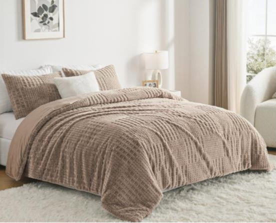 Brown textured comforter on a bed in a bedroom setting with light decor.