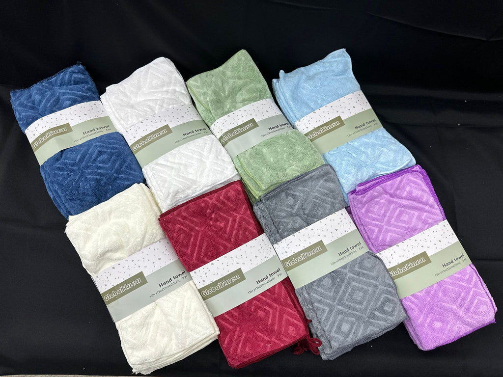 Set of folded towels in various colors on a black background