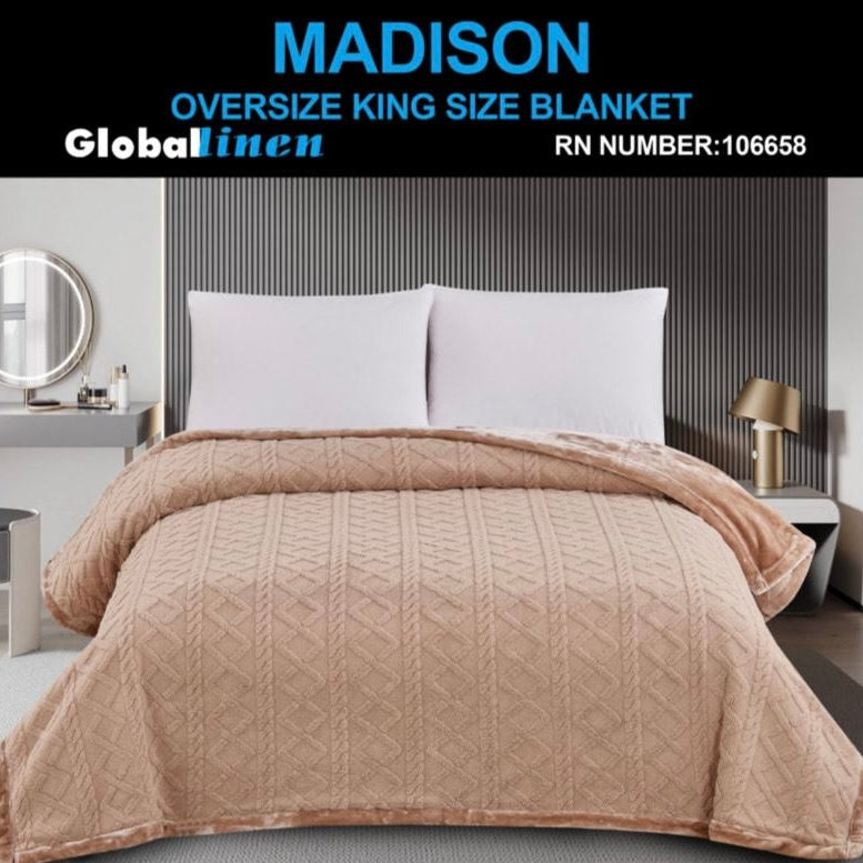 Beige oversized king size blanket on a bed with 'Madison' branding.