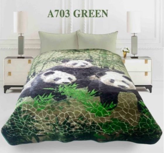 Panda-themed blanket on a bed with 'A703 Green' text above.
