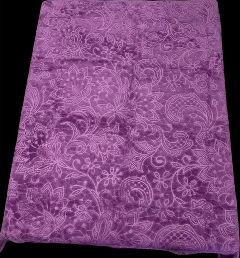 Purple velvet blanket with embossed floral pattern.