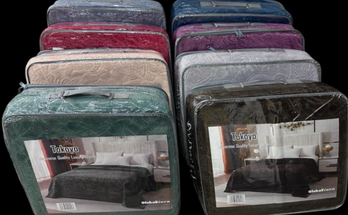 Packaged Tokyo bed covers in various colors with visible brand logo.